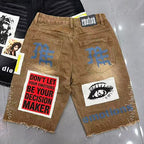 MIXED EMOTION Photo‑Patch Raw‑Hem Denim Shorts