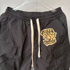 MIXED EMOTION Crest Patch Wide‑Leg Cargo Pants