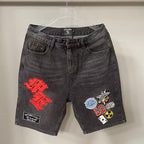 MIXED EMOTION Multi‑Patch Gothic Logo Black Denim Jorts