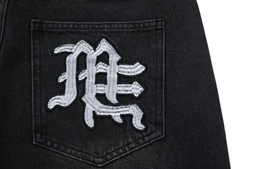MIXED EMOTION Multi‑Patch Gothic Logo Black Denim Jorts