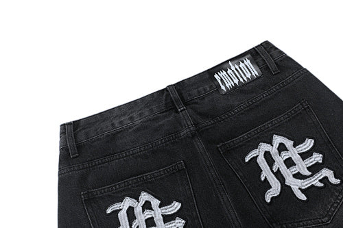 MIXED EMOTION Multi‑Patch Gothic Logo Black Denim Jorts