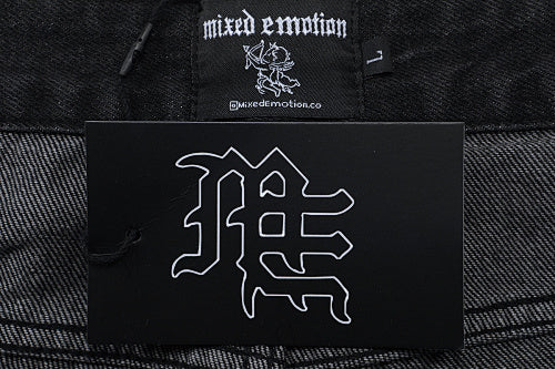 MIXED EMOTION Multi‑Patch Gothic Logo Black Denim Jorts