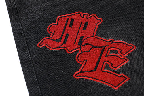 MIXED EMOTION Multi‑Patch Gothic Logo Black Denim Jorts